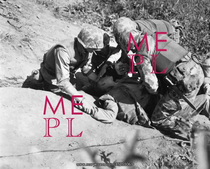 : U.S. Marine is given a drink of water as he waits : U.S. Marine is given a drink of water as he waits