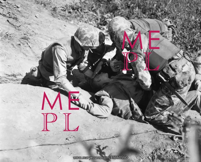 : U.S. Marine is given a drink of water as he waits : U.S. Marine is given a drink of water as he waits