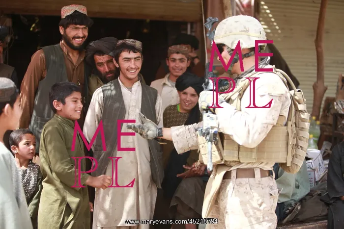 : A U.S. Marine talks with Afghans in the ? : A U.S. Marine talks with Afghans in the ?