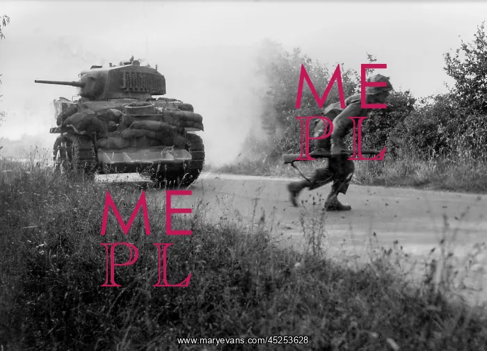 : U.S. soldier crosses a road cautiously under the : U.S. soldier crosses a road cautiously under the