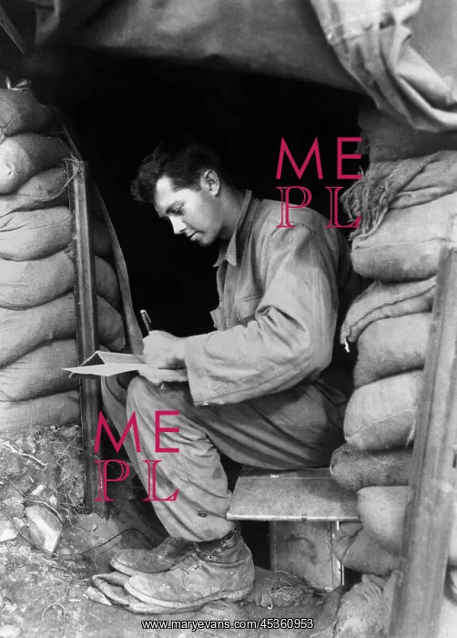 : U.S. soldier writes a letter during a break along : U.S. soldier writes a letter during a break along