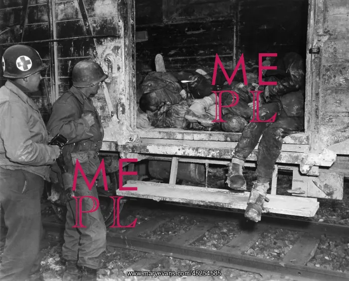 : Two U.S. soldiers looking at dead prisoners on : Two U.S. soldiers looking at dead prisoners on