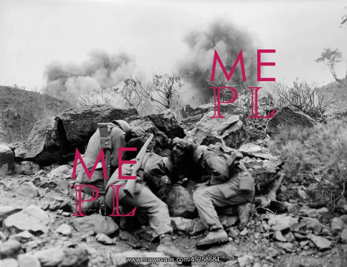 : U.S. soldiers behind rocks to shield themselves : U.S. soldiers behind rocks to shield themselves