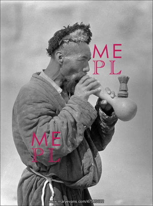 : A Uyghur man smoking an elaborate pipe : A Uyghur man smoking an elaborate pipe