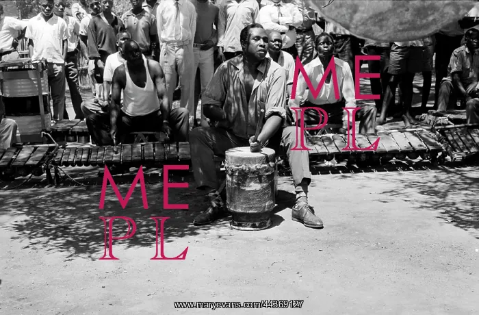 : Venancio Mbande playing nzoma drum during entry movement : Venancio Mbande playing nzoma drum during entry movement