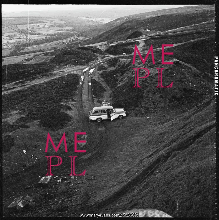 : A view looking down towards a car parked beside : A view looking down towards a car parked beside