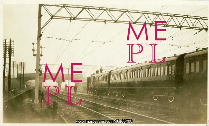 : View of passenger train on track and overhead contact : View of passenger train on track and overhead contact