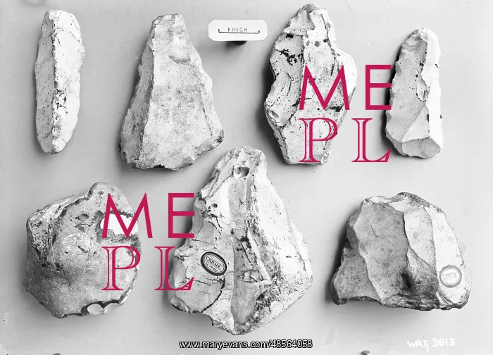 : A view of small flints on a grey background : A view of small flints on a grey background