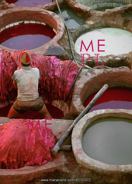 : Fez. View from behind of a tanner in pits of red dye : Fez. View from behind of a tanner in pits of red dye