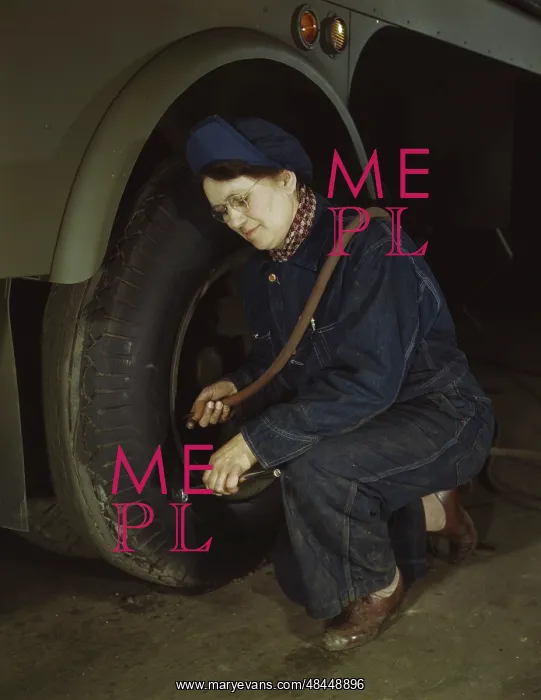 : War production worker checking the tires of : War production worker checking the tires of