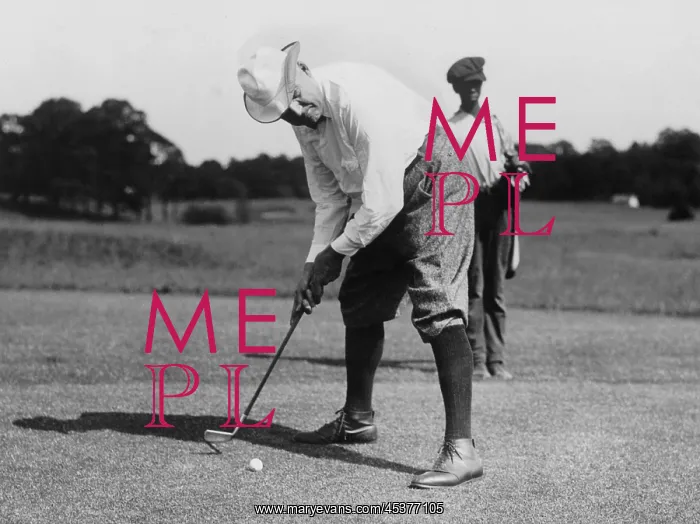 : Warren G. Harding bending over to hit a golf : Warren G. Harding bending over to hit a golf