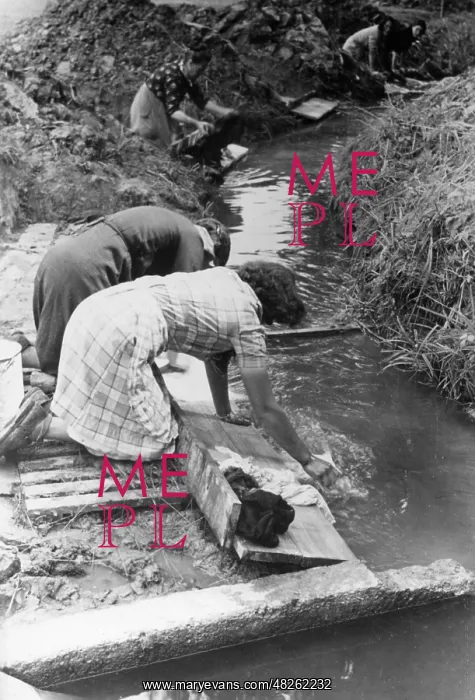: Washing day in a refugee camp, 1940 : Washing day in a refugee camp, 1940
