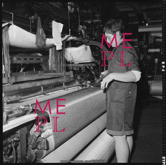 : A weaver preparing a shuttle for use in a power loom : A weaver preparing a shuttle for use in a power loom