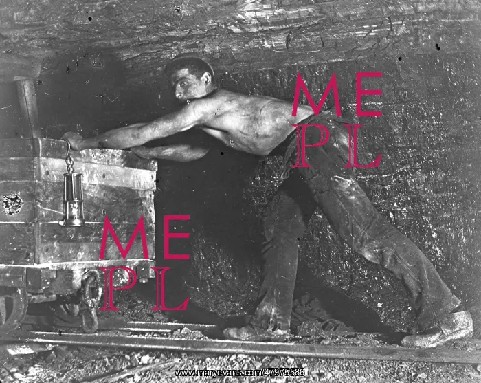 : Welsh miner in coal mine pushing truck : Welsh miner in coal mine pushing truck