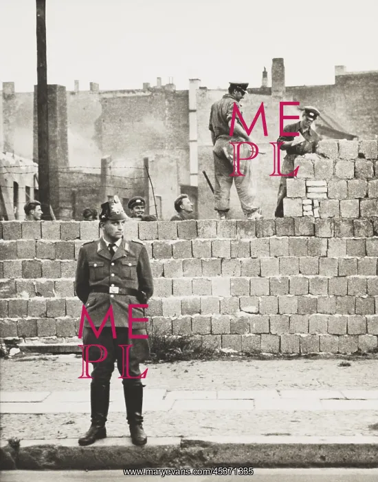 : West Berlin policeman stands before the concrete : West Berlin policeman stands before the concrete