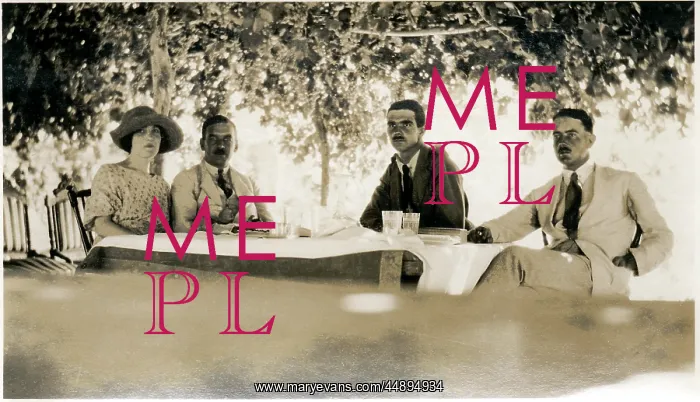 : Four Westerners at a table in the shade, Middle East : Four Westerners at a table in the shade, Middle East