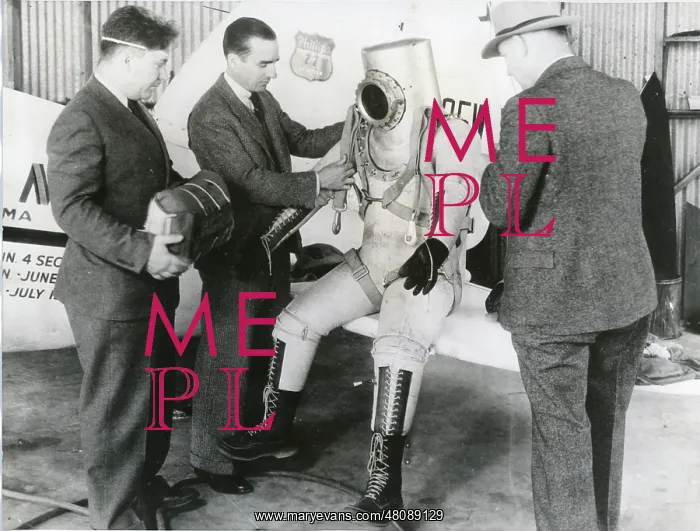 : Wiley Post makes a final examination of his pressure suit : Wiley Post makes a final examination of his pressure suit