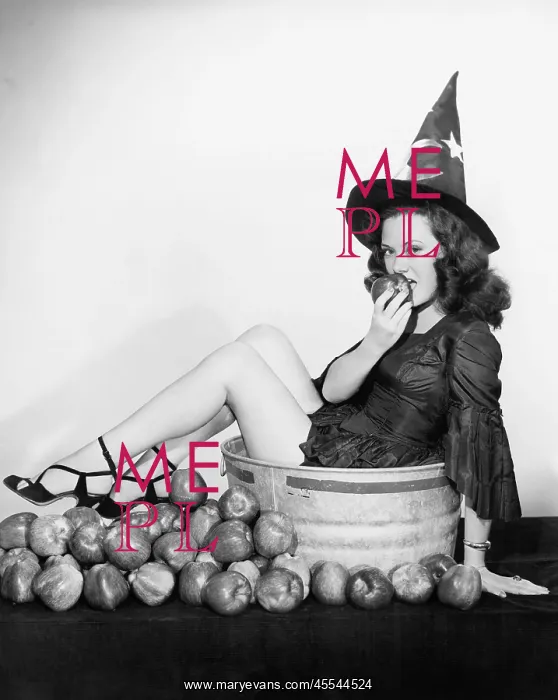  : A wizardly woman takes a bite out of a big apple