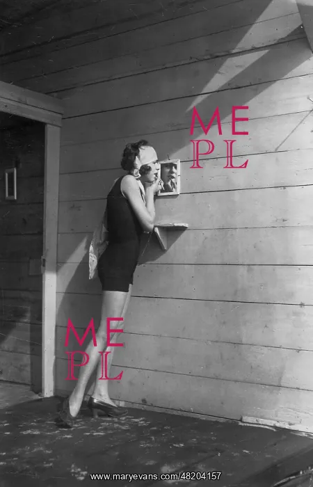 : A woman applying make-up at the beach, 1926 : A woman applying make-up at the beach, 1926