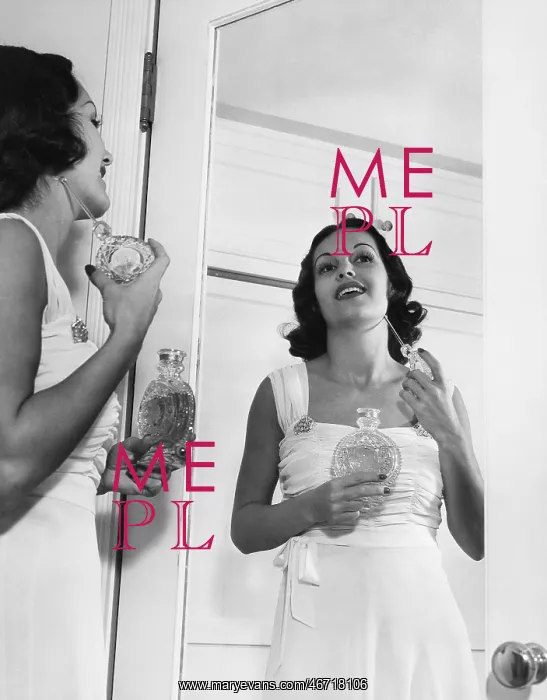  : Woman applying perfume at mirror