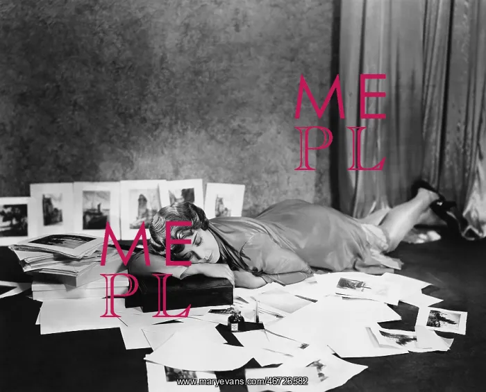 : Woman asleep on floor surrounded by illustrations : Woman asleep on floor surrounded by illustrations