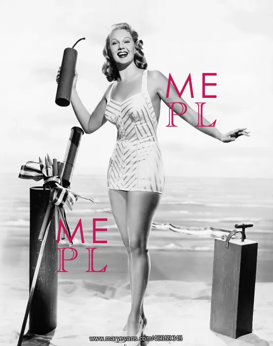 : Woman in a bathing suit at the beach holding an : Woman in a bathing suit at the beach holding an