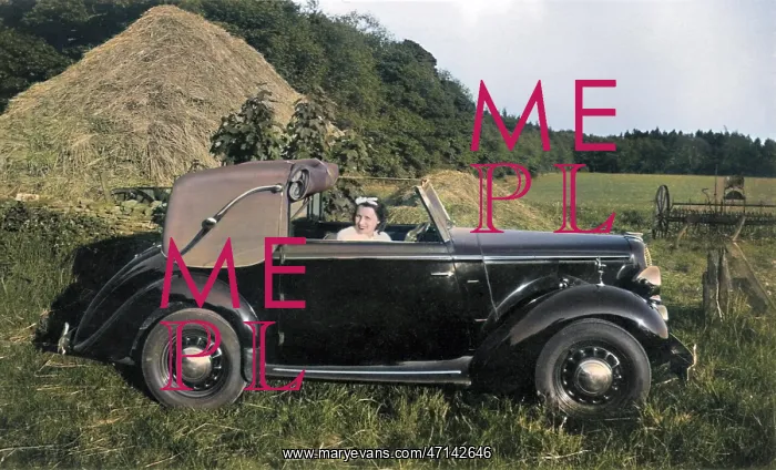 : Woman in a car near a haystack : Woman in a car near a haystack