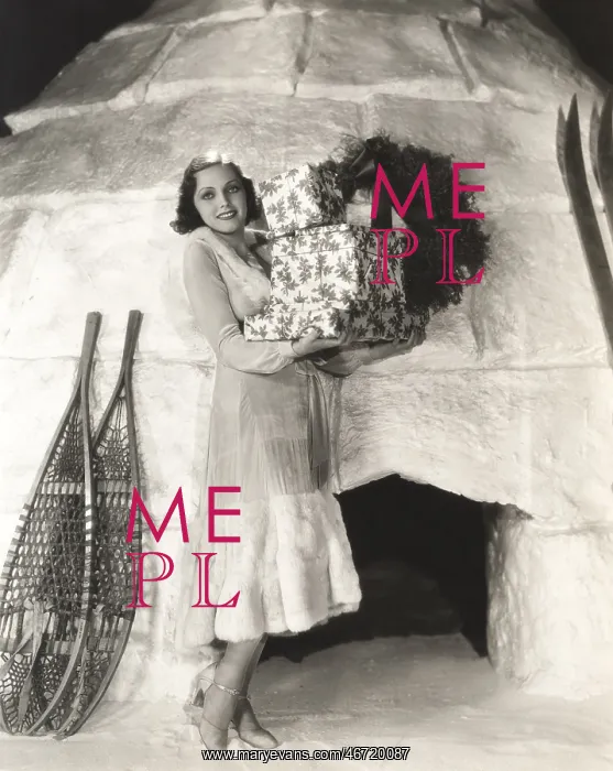 : Woman carrying gift boxes outside igloo : Woman carrying gift boxes outside igloo