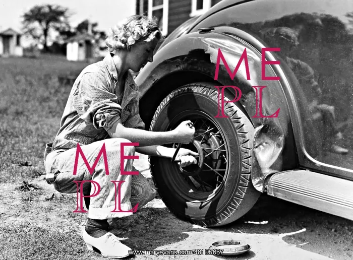 : Woman changing a tire, 1937 : Woman changing a tire, 1937