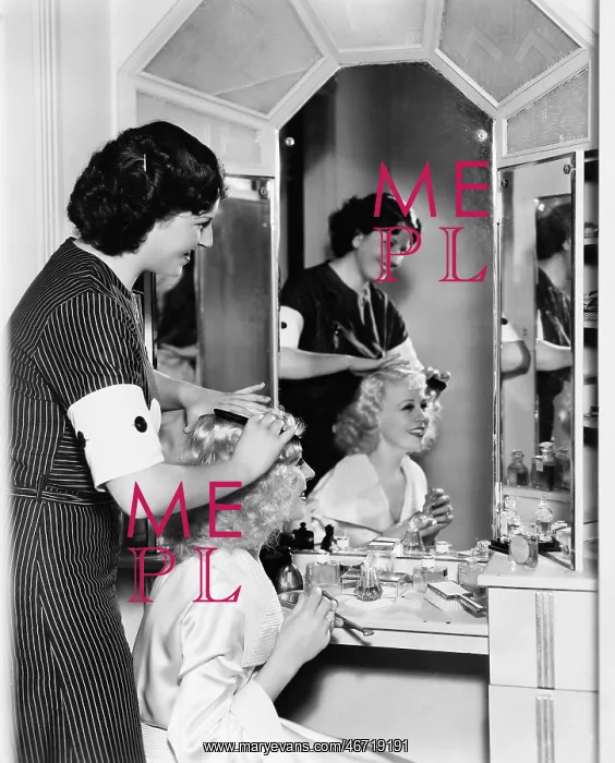 : Woman combing another womans hair : Woman combing another womans hair