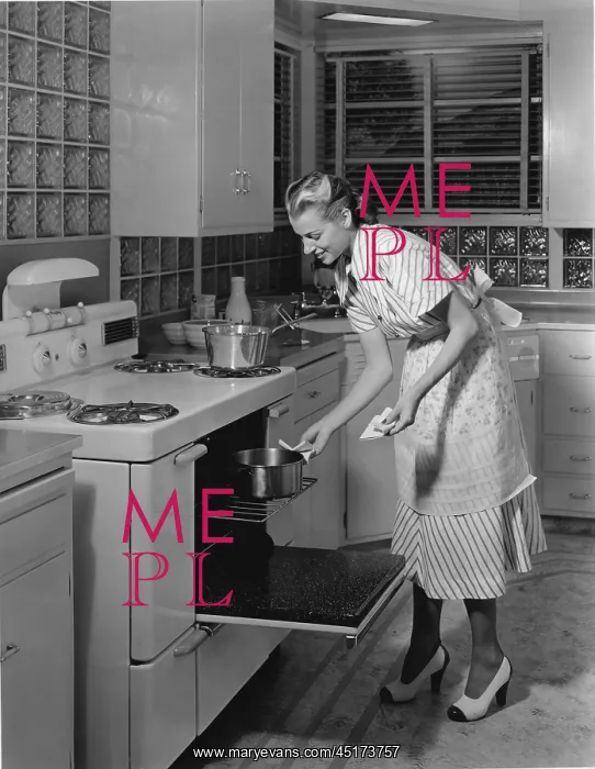 : Woman cooking in her kitchen : Woman cooking in her kitchen