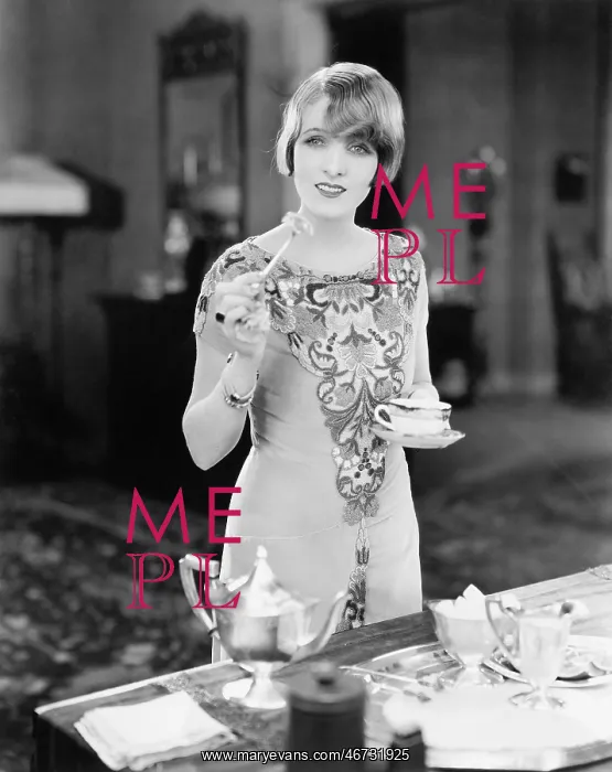 : Woman with a cup of tea and a canap in her hands : Woman with a cup of tea and a canap in her hands
