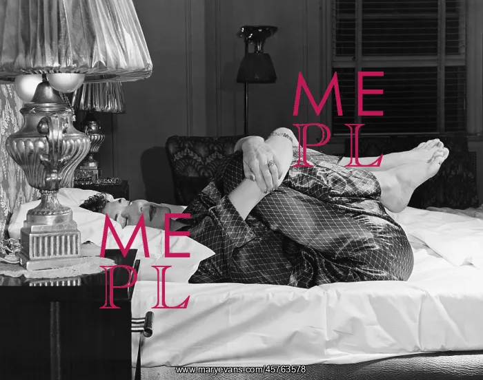 : Woman curling up on a bed : Woman curling up on a bed