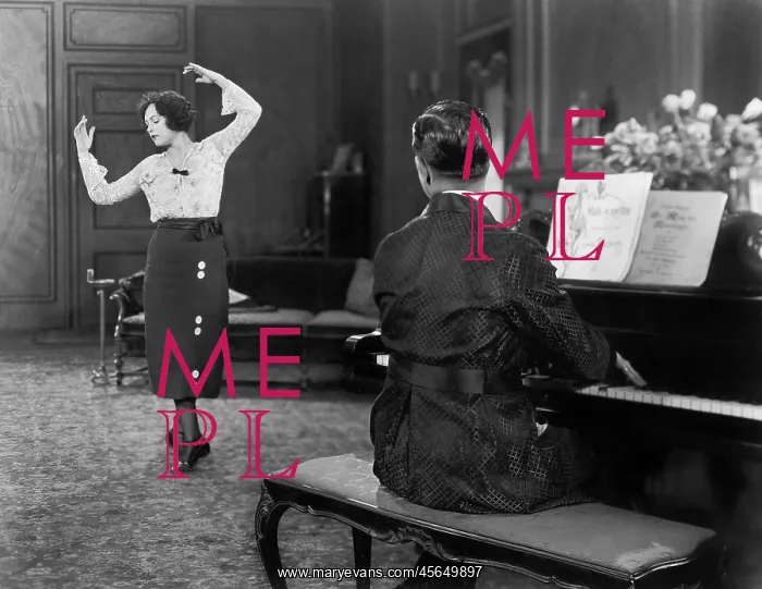 : Woman dancing while her husband is playing the piano : Woman dancing while her husband is playing the piano