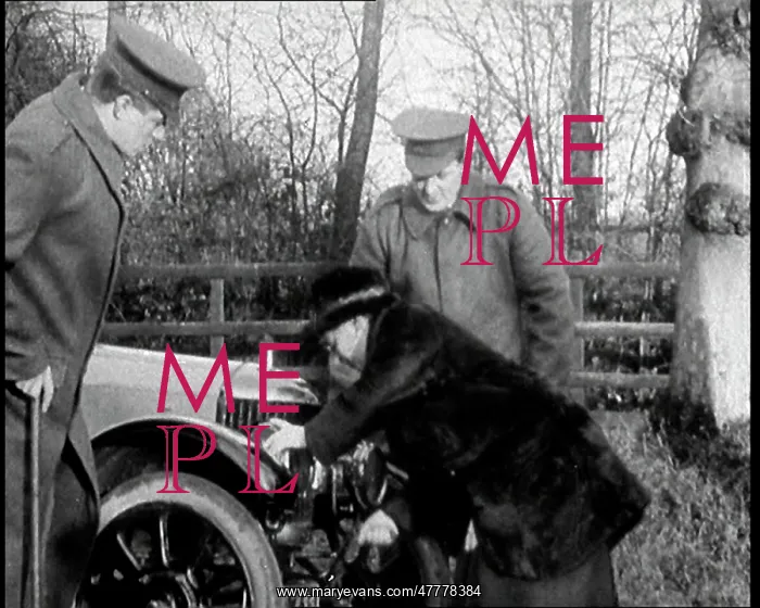 : A Woman Demonstrating How To Start A Motorcar : A Woman Demonstrating How To Start A Motorcar