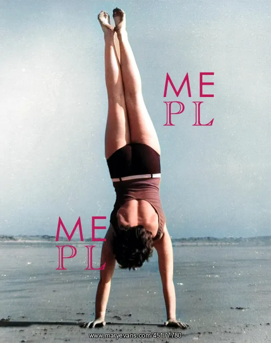  : Woman doing handstand on beach