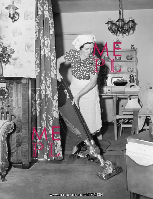  : Woman doing housework with a vacuum cleaner