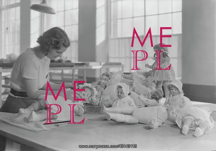 : Woman dressing and packing dolls, 1936 : Woman dressing and packing dolls, 1936