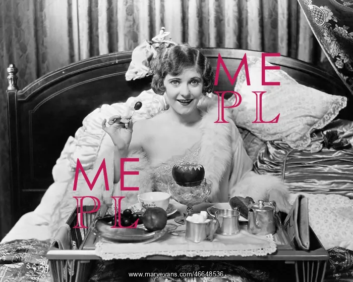 : Woman eating breakfast in bed : Woman eating breakfast in bed