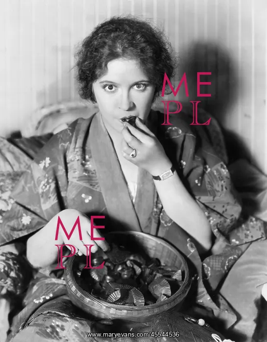 : Woman eating chocolates out of a bowl : Woman eating chocolates out of a bowl