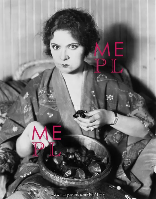 : Woman eating chocolates out of a bowl : Woman eating chocolates out of a bowl
