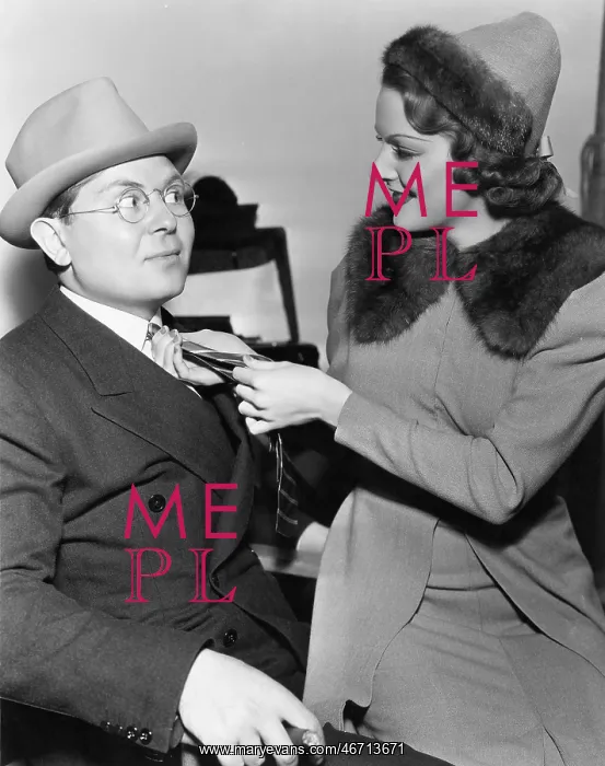: Woman fixing mans tie : Woman fixing mans tie