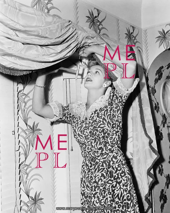 : Woman hanging a valance : Woman hanging a valance