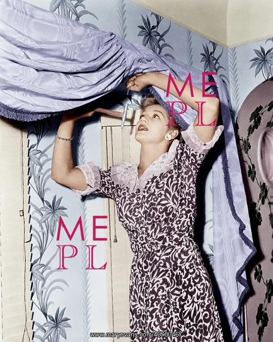 : Woman hanging a valance : Woman hanging a valance