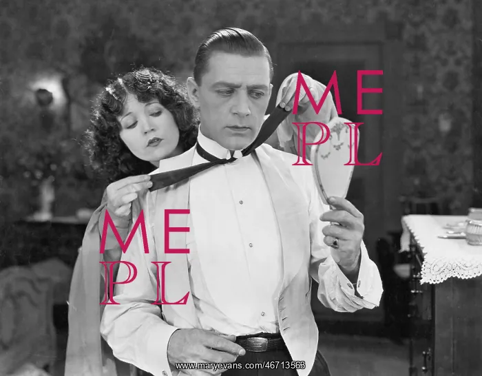 : Woman helping man tie bow tie : Woman helping man tie bow tie
