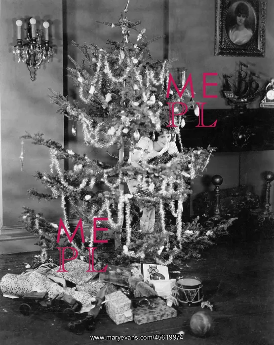 : Woman hiding in a decorated Christmas tree : Woman hiding in a decorated Christmas tree