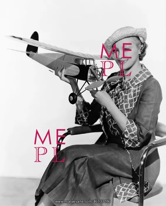 : Woman holding model airplane : Woman holding model airplane