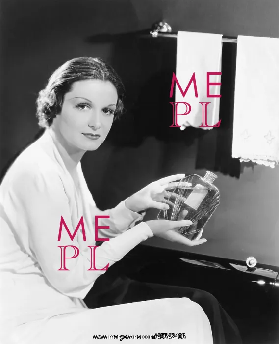  : Woman holding an oversized bottle of perfume