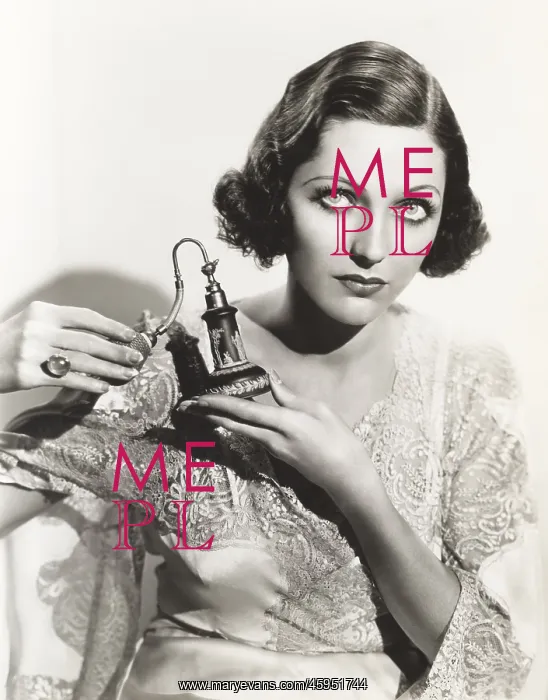 : Woman holding perfume atomizer : Woman holding perfume atomizer