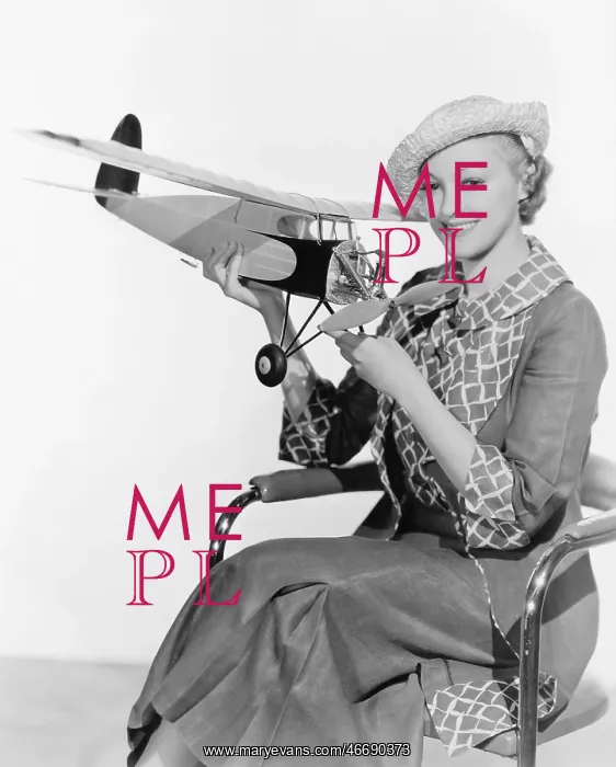 : Woman holding a toy plane : Woman holding a toy plane